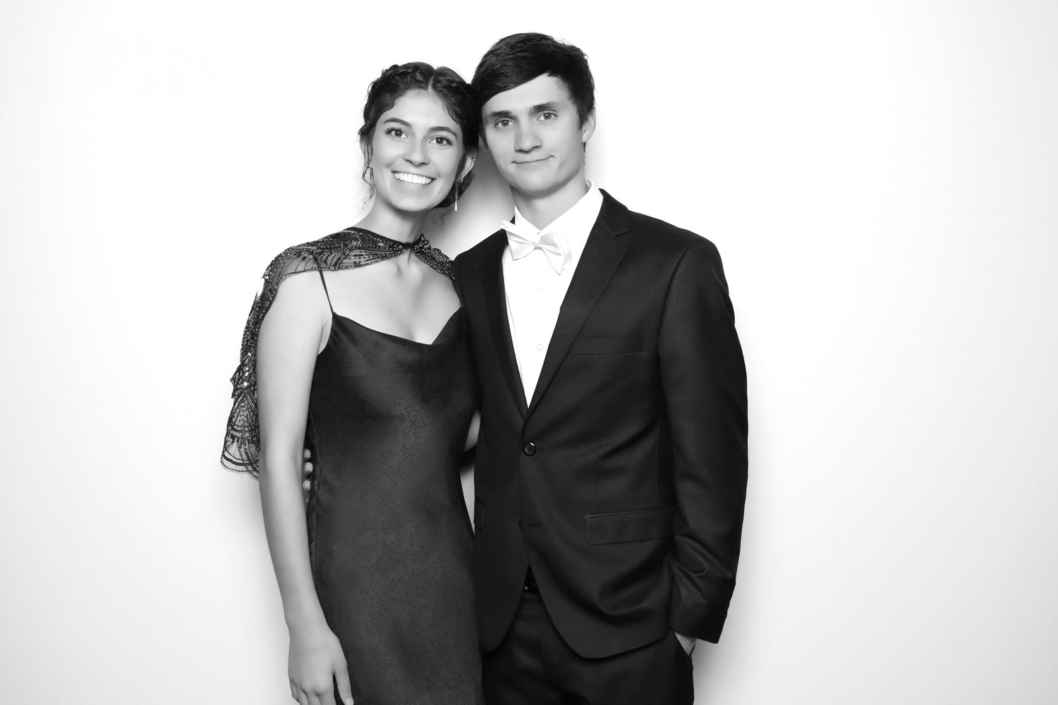 Black and white photo of a man and woman posing together against a plain background, amber and judson payton, wedding florist, atlanta wedding flowers