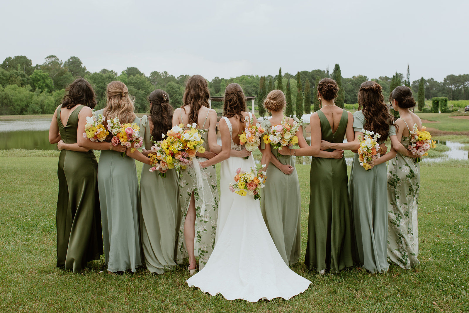 bridesmaids in green dresses holding colorful garden style bouquets, wedding florist atlanta georgia