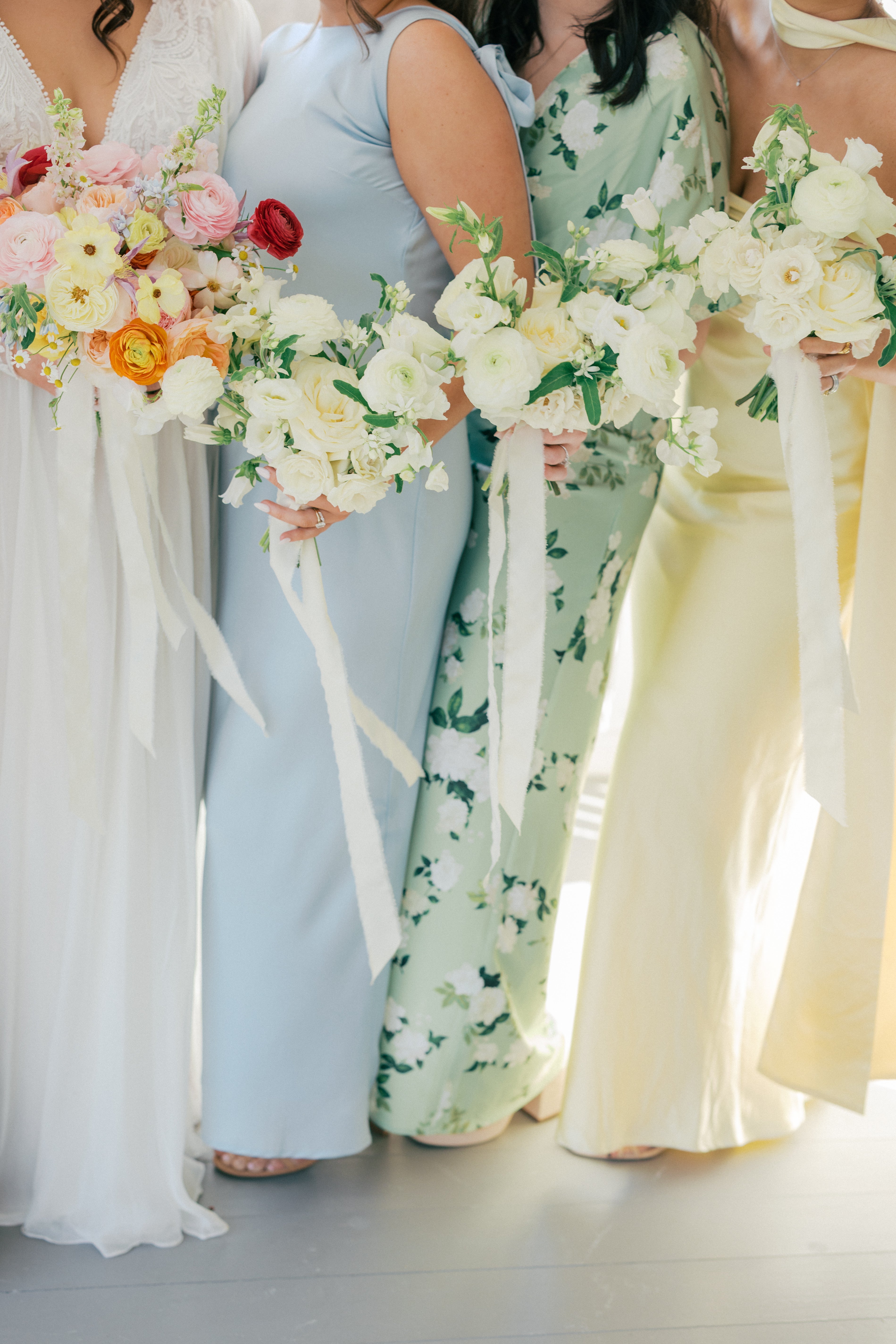 Elegant bridal bouquet in blush and cream tones with flowing ribbon