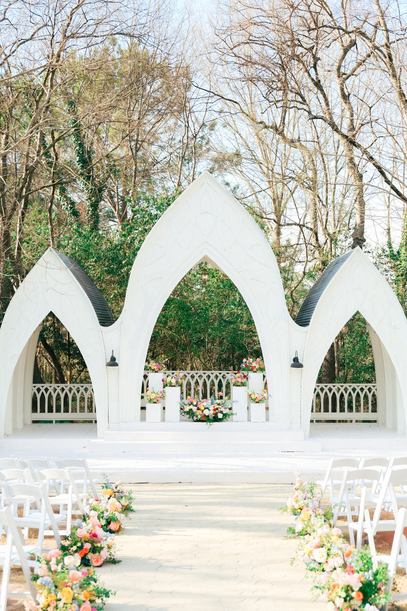 White archway with florals at the Wildflower 301