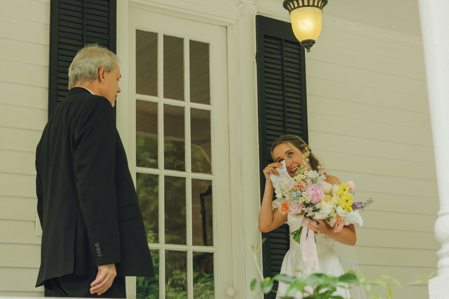 Bride holding a bouquet of flowers Elegant bridal bouquet with blush peonies, roses, and chamomile by Refined Studio Atlanta