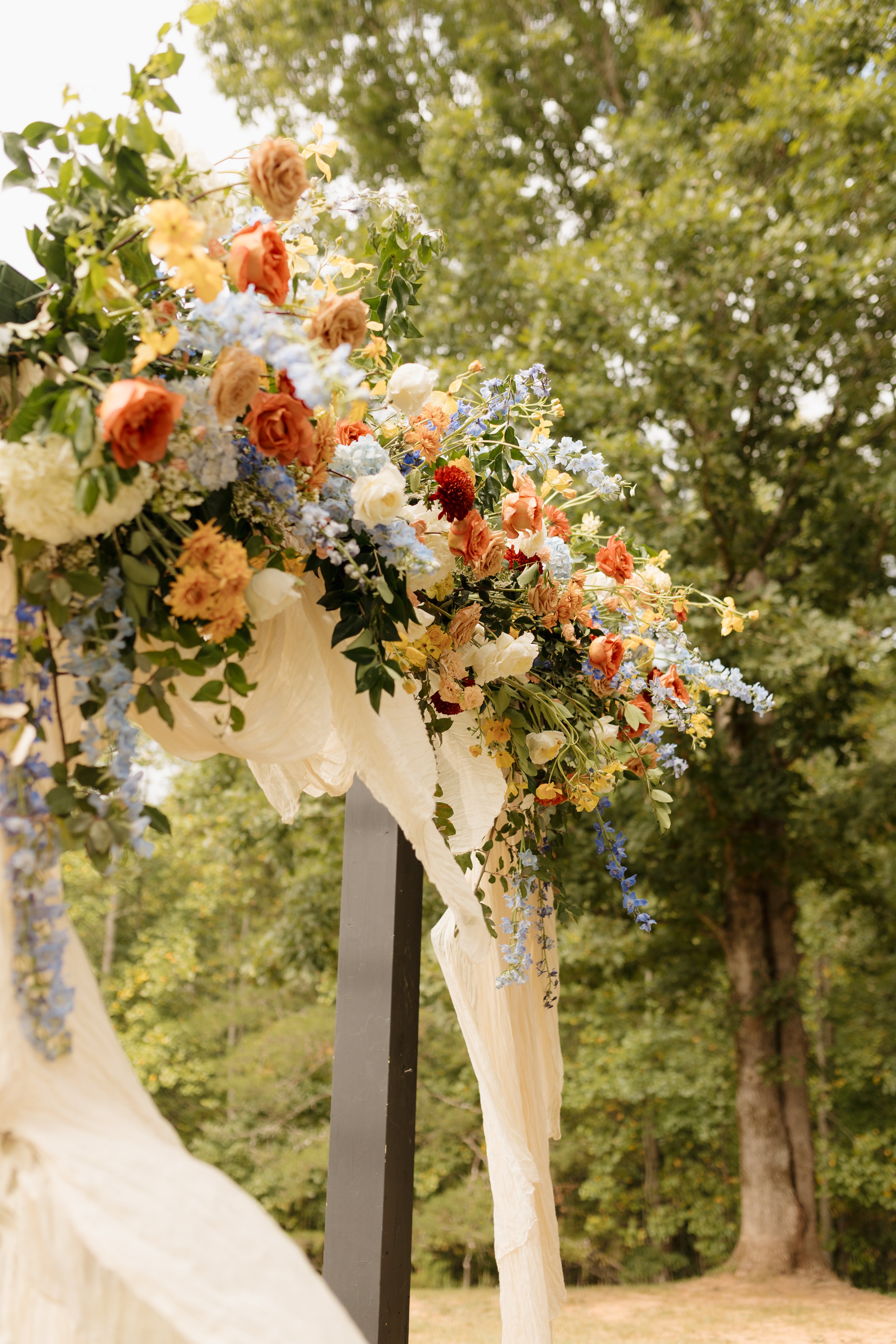 Lush wedding arch with roses, delphinium, peonies and seasonal greenery, Atlanta florist, fall colors, autumn colors