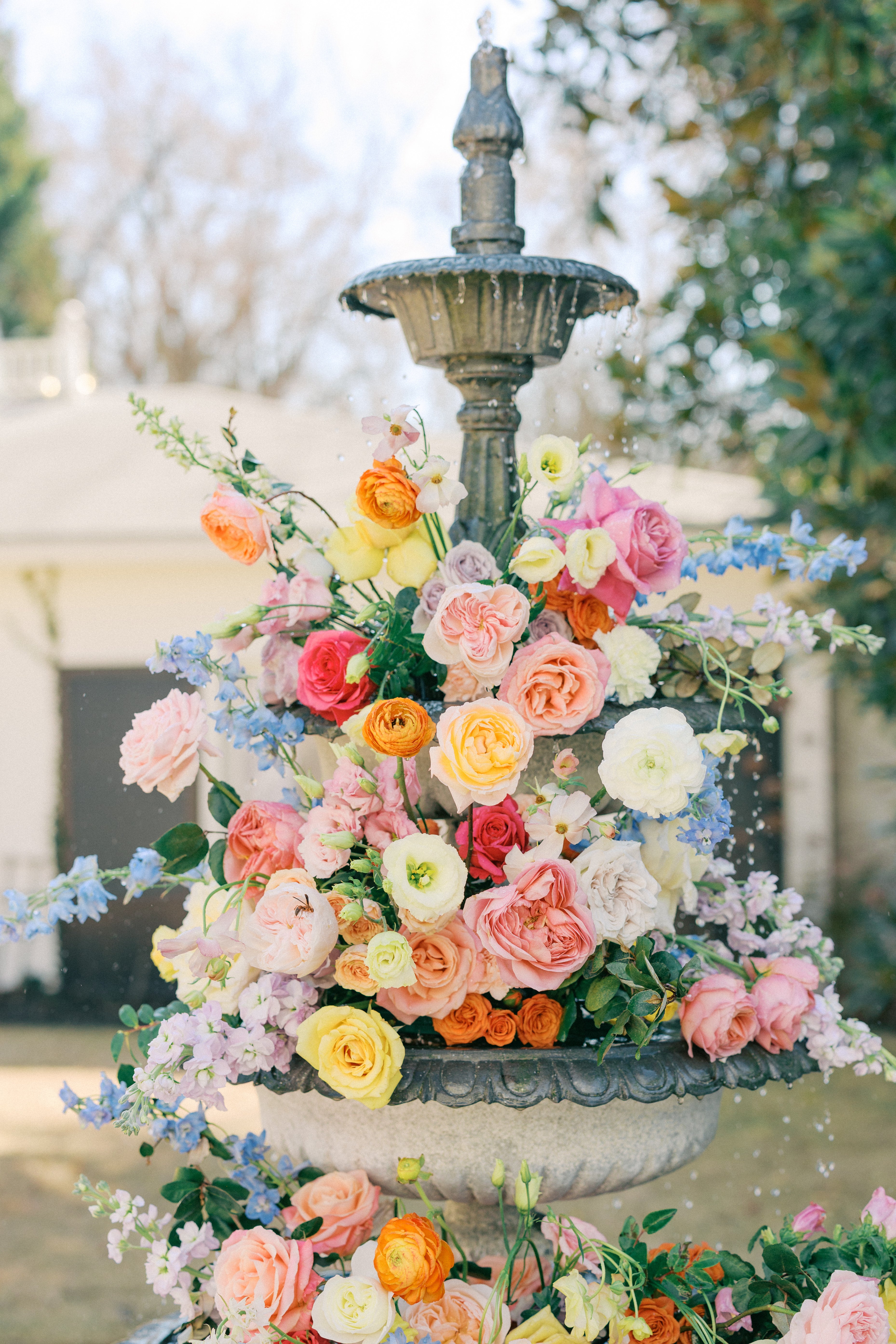 Decorative fountain with colorful flowers in a garden setting at the wildflower 301
